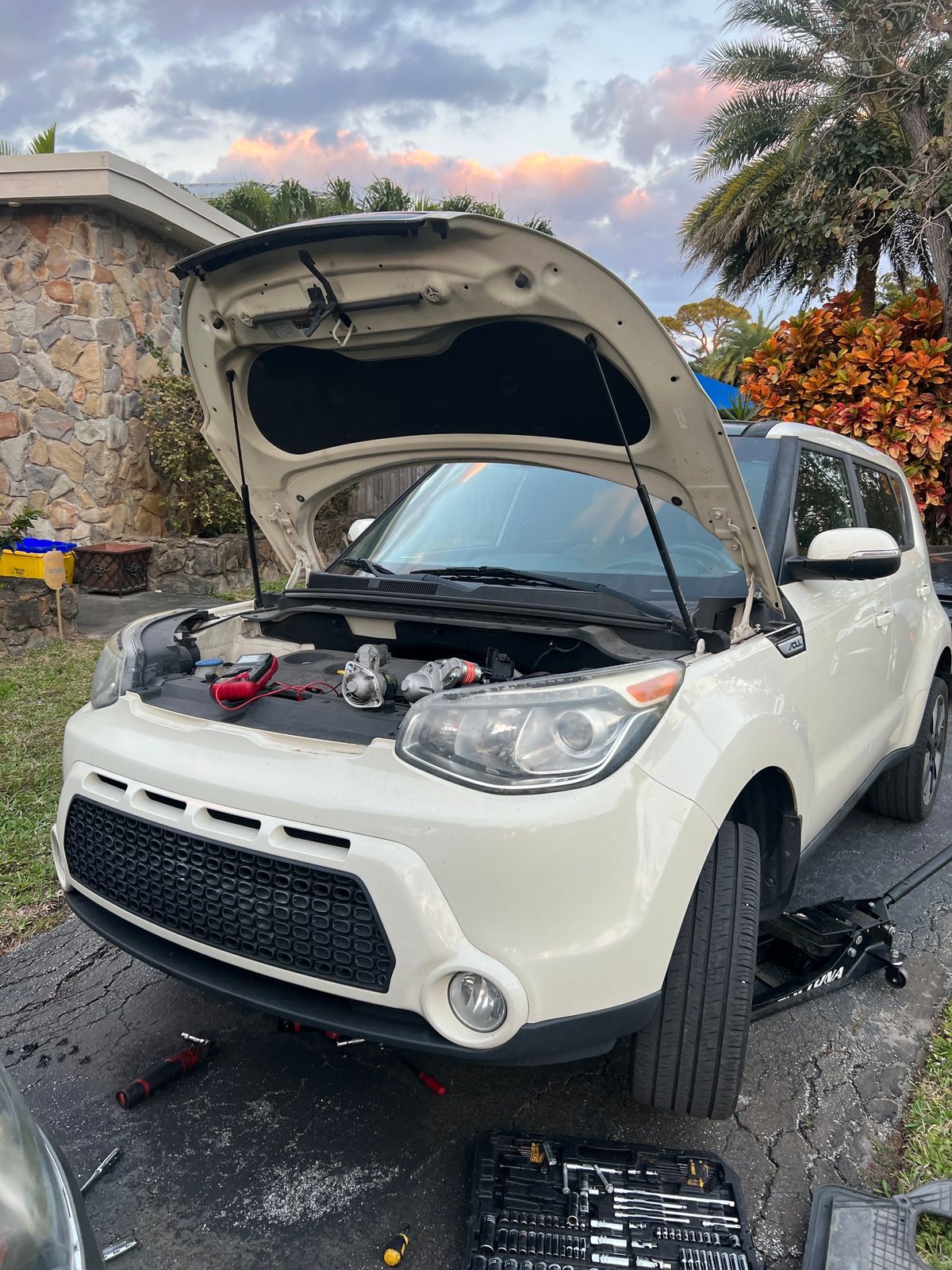 A Kia Soul diagnosed in a Greenacres driveway